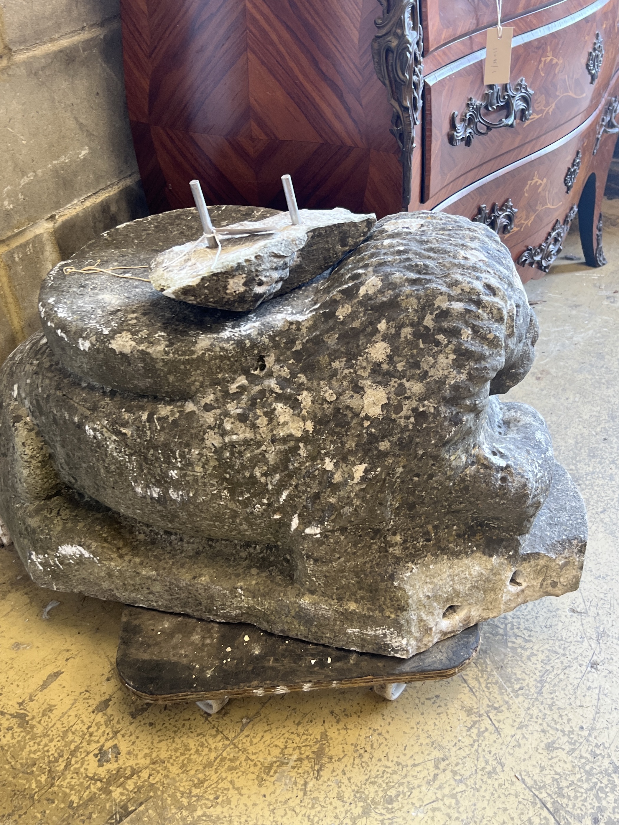 A carved stone lion, (probably antique and a column support) length 84cm, depth 40cm, height 45cm